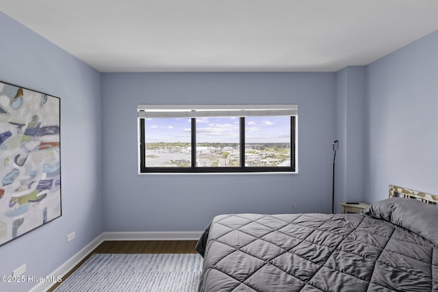 322 Causeway Dr Ste 1001, Wrightsville Beach, NC 28480 - bedroom with dark wood-style flooring and baseboards