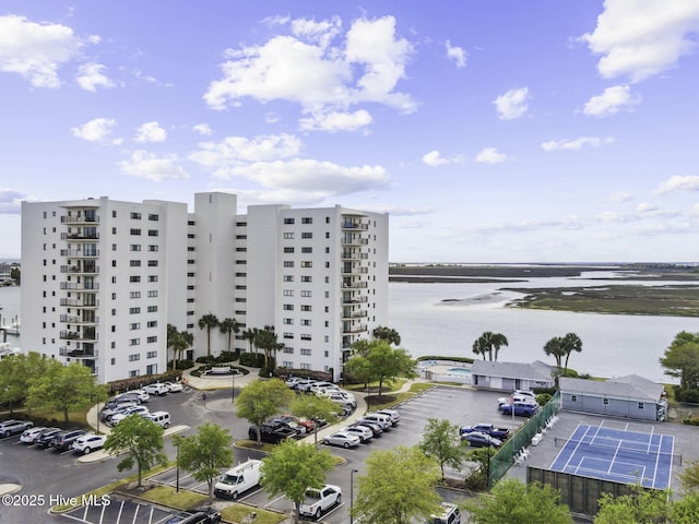 322 Causeway Dr Ste 1001, Wrightsville Beach, NC 28480 - view of building exterior featuring uncovered parking and a water view