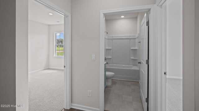 full bathroom with shower / bath combination, baseboards, and toilet