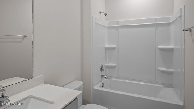 full bathroom with vanity, shower / tub combination, and toilet