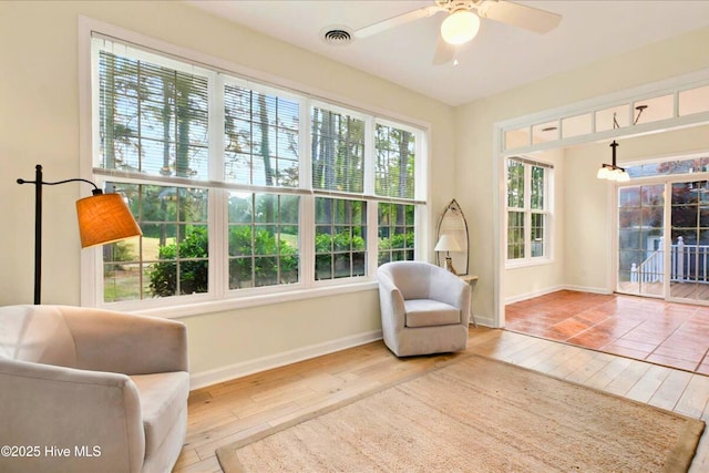 154 Windsor Cir SW, Ocean Isle Beach, NC 28469 - living area featuring wood-type flooring, baseboards, a ceiling fan, and a chandelier