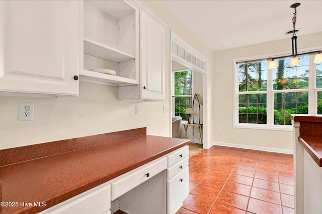 154 Windsor Cir SW, Ocean Isle Beach, NC 28469 - kitchen featuring dark countertops, white cabinets, and pendant lighting