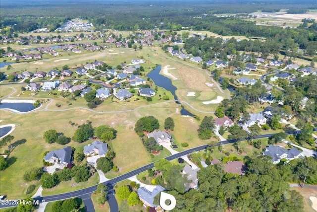 154 Windsor Cir SW, Ocean Isle Beach, NC 28469 - aerial view of property and surrounding area featuring a large body of water, nearby suburban area, and a local golf course