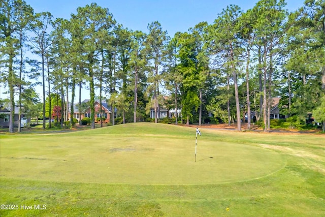 154 Windsor Cir SW, Ocean Isle Beach, NC 28469 - view of home's community featuring view of golf course, a putting area, and a lawn
