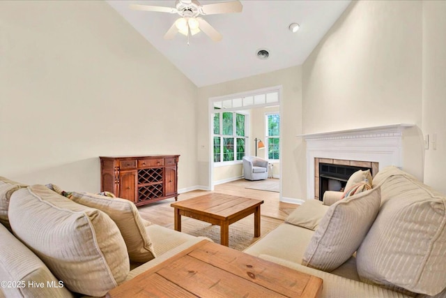 154 Windsor Cir SW, Ocean Isle Beach, NC 28469 - living room featuring high vaulted ceiling, ceiling fan, a tile fireplace, light wood-style flooring, and baseboards