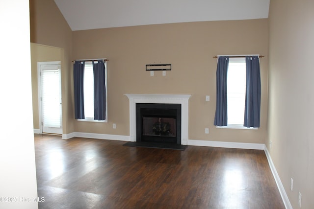 107 Pinyon Ln, Ayden, NC 28513 - unfurnished living room with a fireplace with flush hearth, dark wood-type flooring, baseboards, and vaulted ceiling