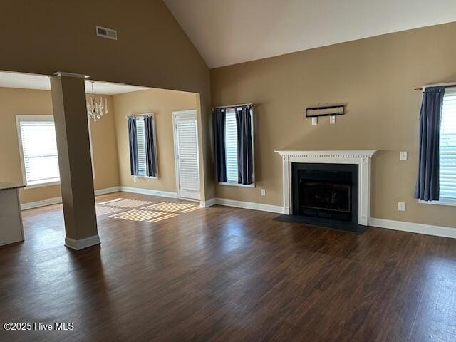 107 Pinyon Ln, Ayden, NC 28513 - unfurnished living room featuring an inviting chandelier, dark wood finished floors, a fireplace with flush hearth, visible vents, and baseboards