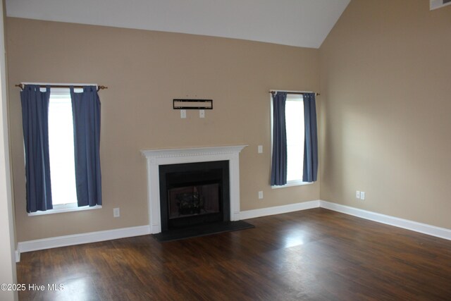 107 Pinyon Ln, Ayden, NC 28513 - unfurnished living room with baseboards, wood finished floors, and lofted ceiling