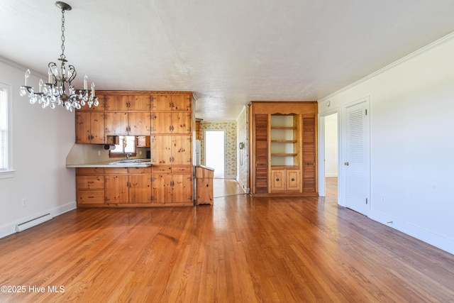 kitchen with baseboards, light wood-type flooring, an inviting chandelier, ornamental molding, and a baseboard radiator