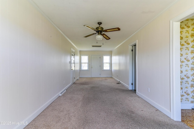 interior space with crown molding, carpet flooring, and baseboards