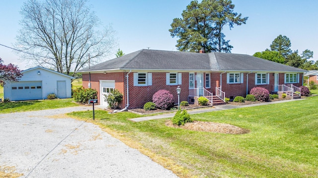 ranch-style house with gravel driveway, brick siding, a front lawn, and an outbuilding