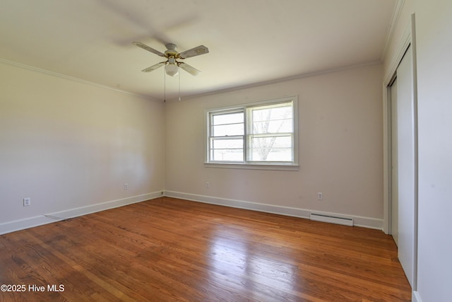 unfurnished bedroom featuring ceiling fan, ornamental molding, visible vents, wood finished floors, and baseboards
