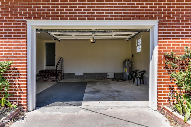 garage with electric water heater and a garage door opener