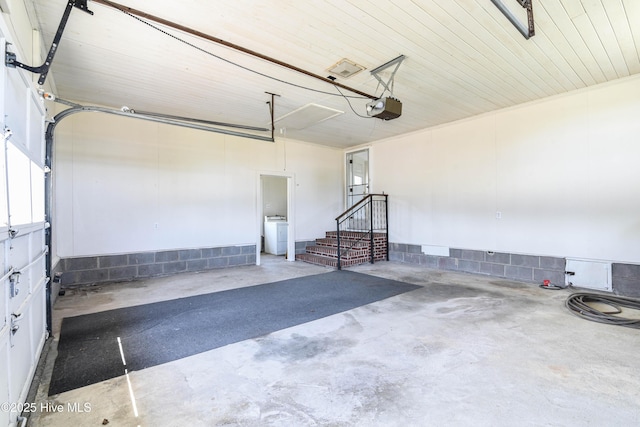 garage featuring washer / dryer and a garage door opener