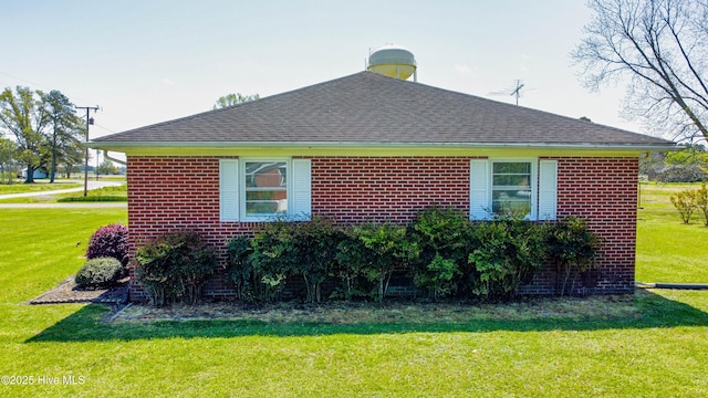 view of property exterior featuring a yard and a shingled roof