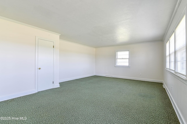 empty room with dark carpet, crown molding, and plenty of natural light