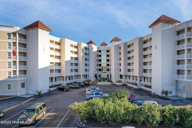 view of building exterior with uncovered parking