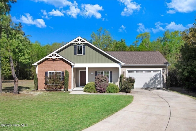 craftsman inspired home with a front yard, an attached garage, and concrete driveway