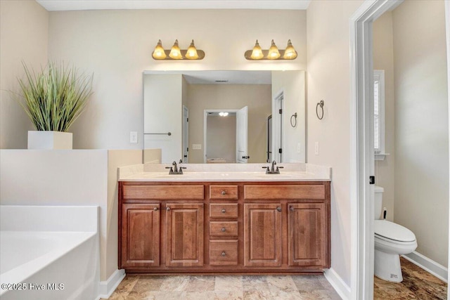 full bathroom featuring double vanity, a garden tub, a sink, and toilet