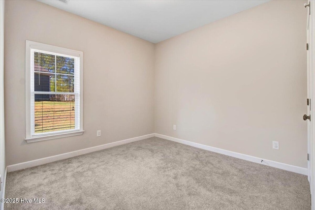 empty room with carpet flooring and baseboards