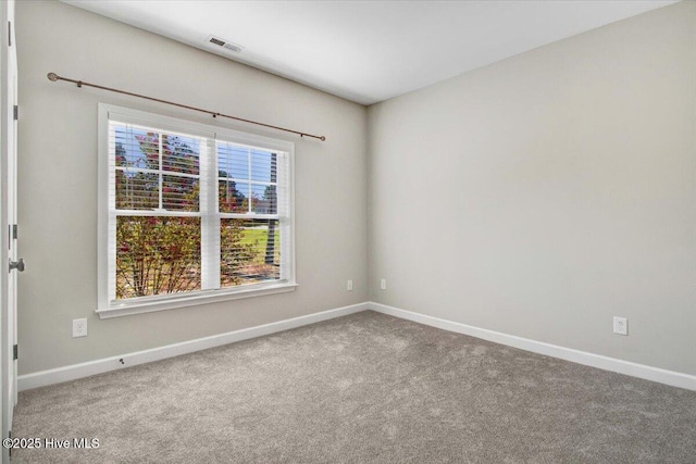 unfurnished room with baseboards, visible vents, and carpet floors
