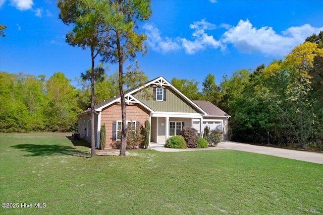 craftsman house with an attached garage, concrete driveway, and a front yard