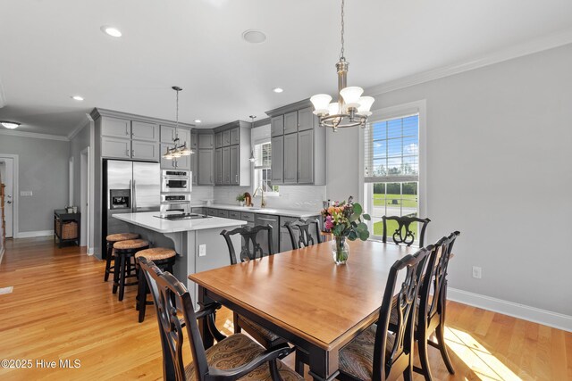 103 Arabian Cir, Beulaville, NC 28518 - dining space with a chandelier, ornamental molding, baseboards, recessed lighting, and light wood-style floors