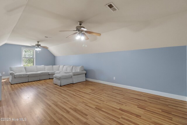 103 Arabian Cir, Beulaville, NC 28518 - unfurnished living room with a ceiling fan, baseboards, vaulted ceiling, and light wood-type flooring