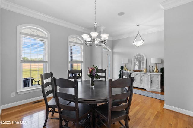 103 Arabian Cir, Beulaville, NC 28518 - dining room featuring a chandelier, light wood-style flooring, crown molding, and baseboards