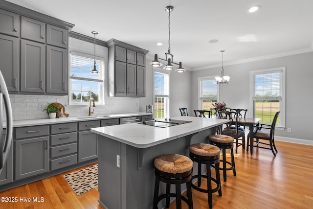 103 Arabian Cir, Beulaville, NC 28518 - kitchen featuring gray cabinets, a sink, ornamental molding, a center island, and light wood-style flooring