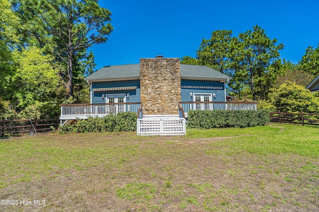 124 Shenandoah Rd E, West End, NC 27376 - rear view of property featuring a wooden deck, a chimney, and french doors