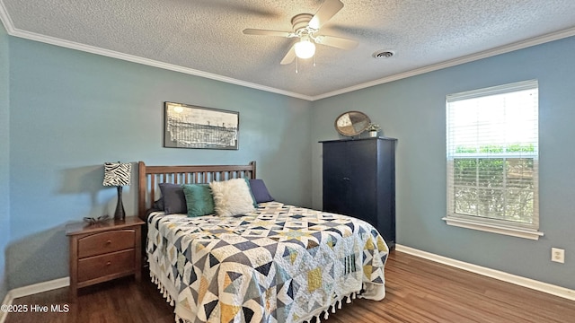 bedroom with visible vents, baseboards, ornamental molding, a textured ceiling, and wood finished floors