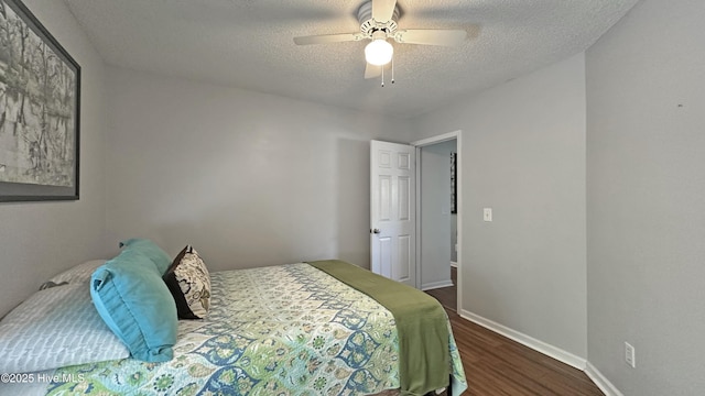 bedroom with a textured ceiling, baseboards, a ceiling fan, and wood finished floors