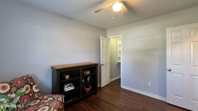 bedroom with dark wood-type flooring, a textured ceiling, ceiling fan, and baseboards