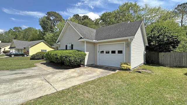 view of side of property featuring a shingled roof, a lawn, a garage, fence, and driveway