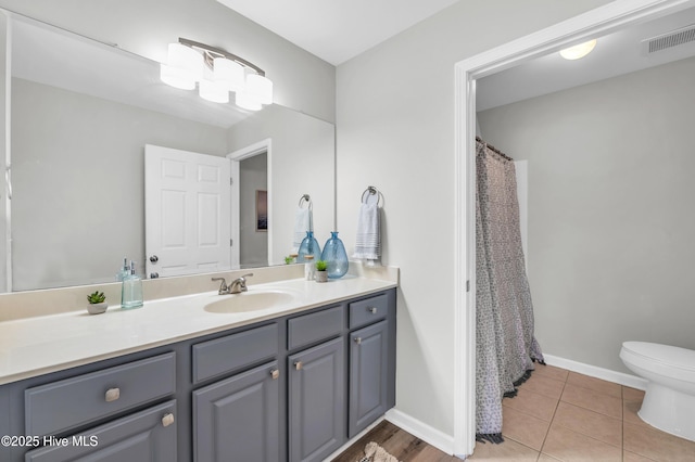 full bath featuring vanity, toilet, baseboards, tile patterned floors, and a shower with curtain