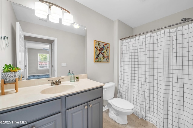 bathroom featuring tile patterned floors, toilet, vanity, and a shower with shower curtain