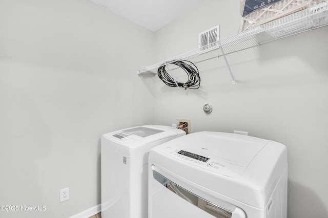 laundry room featuring washing machine and clothes dryer
