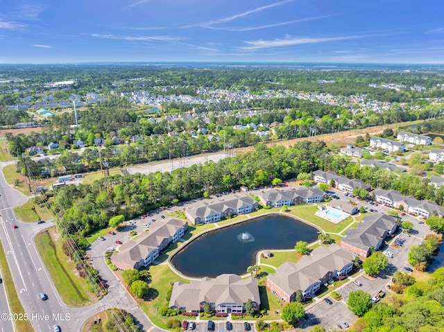 aerial view of property's location featuring nearby suburban area and a large body of water
