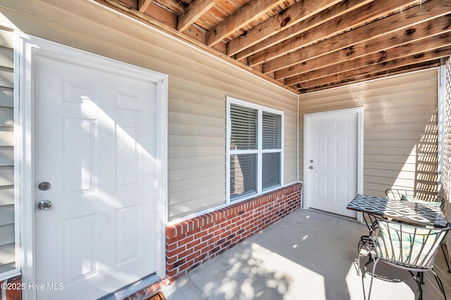 doorway to property with brick siding