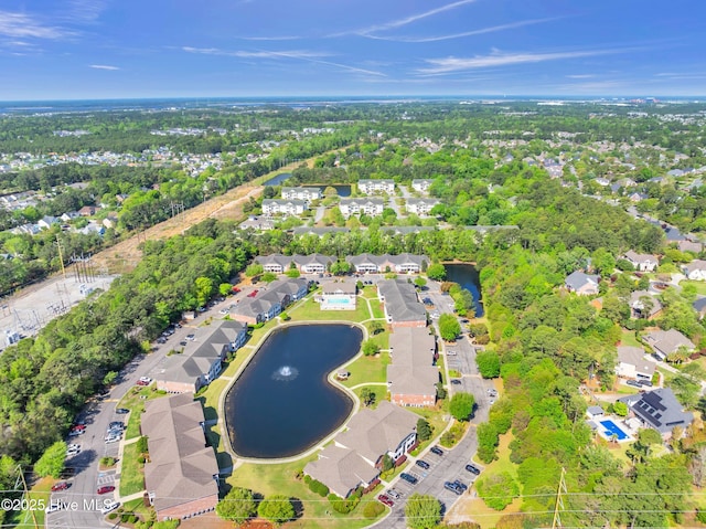 aerial perspective of suburban area with a nearby body of water