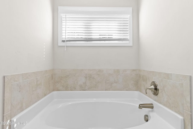 bathroom with a bath and plenty of natural light