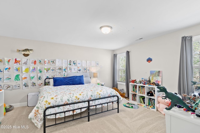 bedroom with carpet flooring, visible vents, and multiple windows