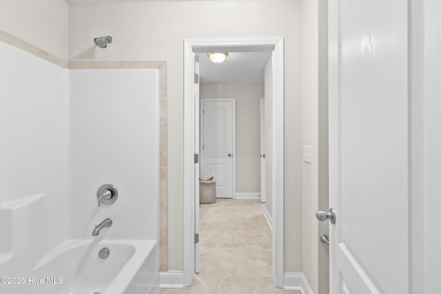 bathroom featuring bathing tub / shower combination, tile patterned floors, and baseboards