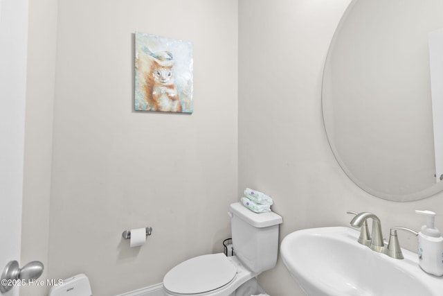 half bath featuring a sink and toilet