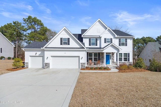 craftsman inspired home featuring a garage, driveway, stone siding, and covered porch