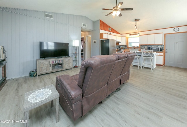 105 Blue Heron Rd, Shiloh, NC 27974 - living area with lofted ceiling, light wood-type flooring, a ceiling fan, and wooden walls