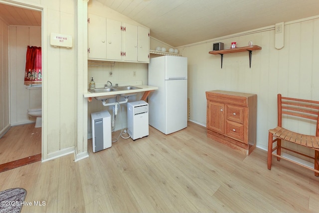 105 Blue Heron Rd, Shiloh, NC 27974 - kitchen featuring freestanding refrigerator, light countertops, light wood finished floors, a sink, and open shelves