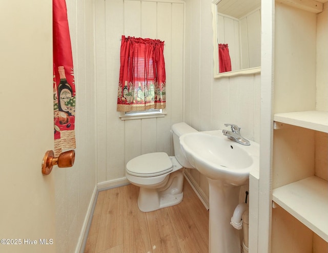 105 Blue Heron Rd, Shiloh, NC 27974 - half bathroom with wood finished floors, toilet, a sink, and baseboards