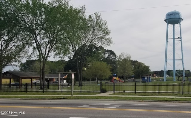 view of home's community with fence, a lawn, and playground community